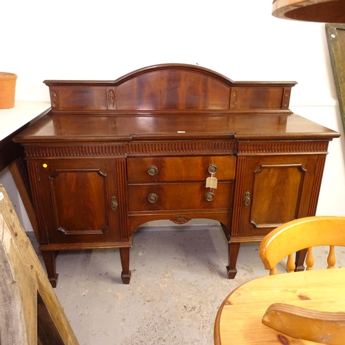 2611 - An Edwardian mahogany inverted break-front sideboard, with raised panelled back, and fitted with dra... 