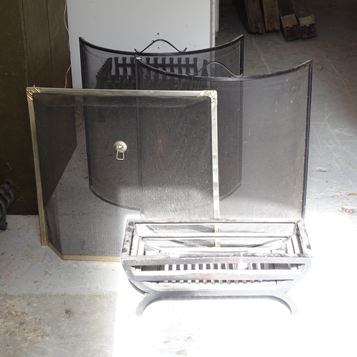 2622 - A small cast-iron fire grate, W55cm, H23cm, and 3 mesh spark guards