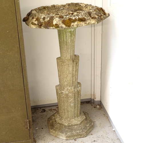 2626 - A weathered concrete birdbath, on an Art Deco style tapered column support, W65cm, H107cm