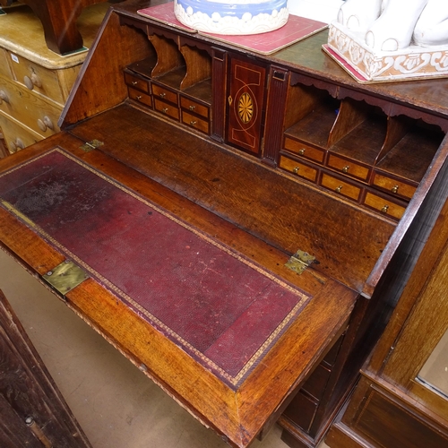 2078 - A Georgian oak bureau, with a crossbanded fitted interior, with 4 long drawers under, W97cm, H108cm,... 