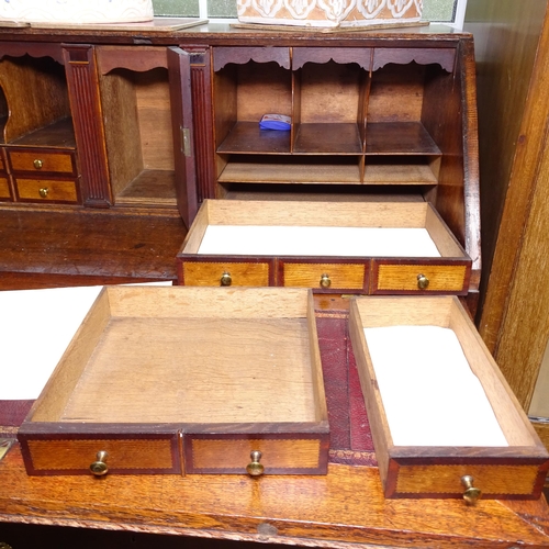 2078 - A Georgian oak bureau, with a crossbanded fitted interior, with 4 long drawers under, W97cm, H108cm,... 