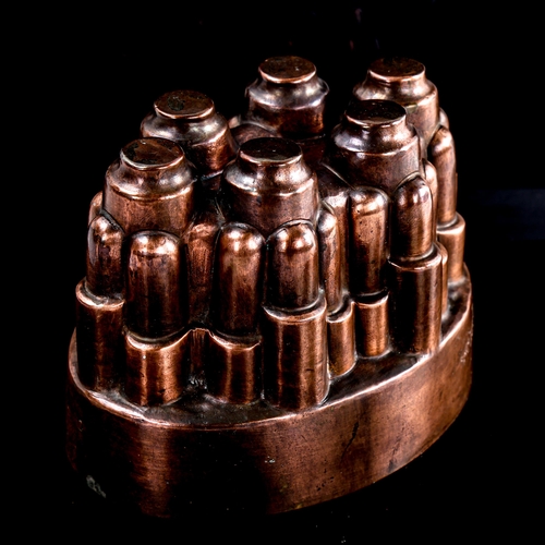 101 - Benham & Froud oval copper jelly mould with 6 turrets, pattern no. 617, height 11cm, length 15.5cm