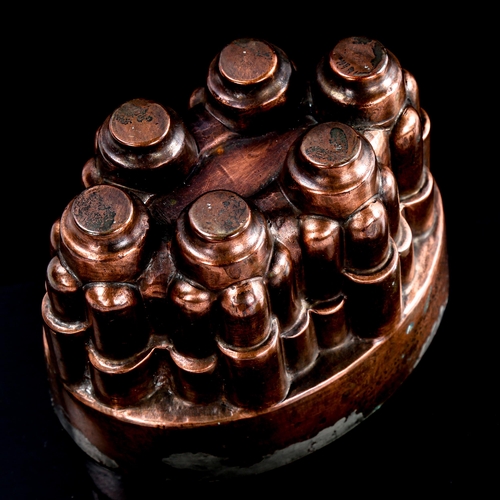 101 - Benham & Froud oval copper jelly mould with 6 turrets, pattern no. 617, height 11cm, length 15.5cm