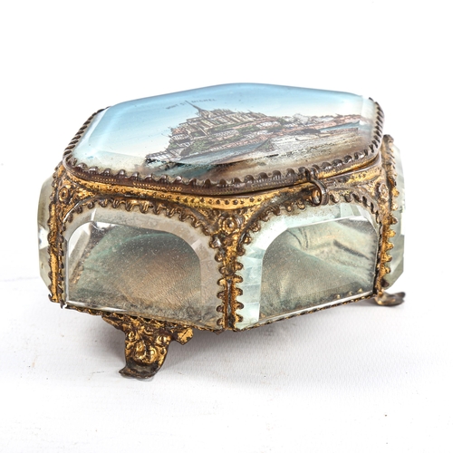 102 - A French gilt-metal jewel casket, with inset bevel glass panels, the lid depicting Mont St Michel, l... 