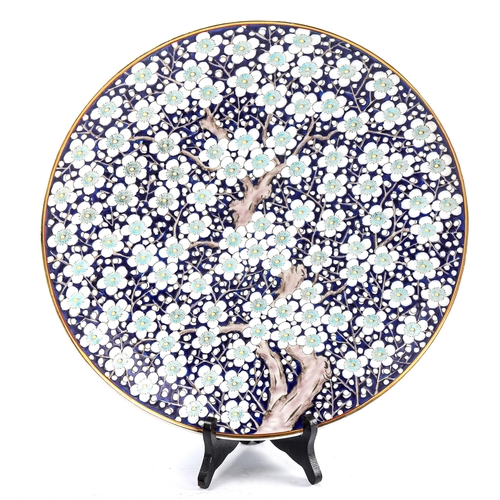 105 - A Japanese porcelain charger with blossom tree decoration, diameter 36cm