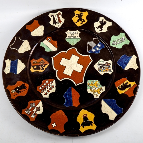 133 - A Continental pottery charger, decorated with Coats of Arms, diameter 45cm