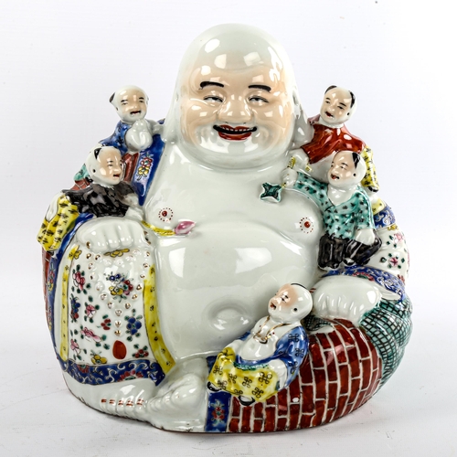 136 - A Chinese porcelain seated Buddha with children, height 26cm, impress mark under base