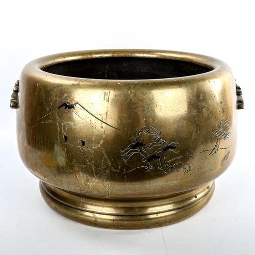 142 - A large Japanese bronze jardiniere, engraved mountain landscapes and cast handles, diameter 35cm, he... 