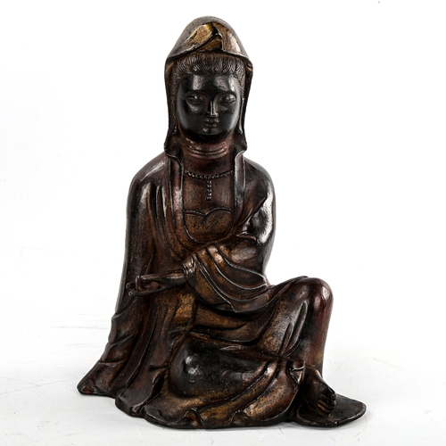 143 - A Chinese patinated seated figure of Guanyin, height 21cm