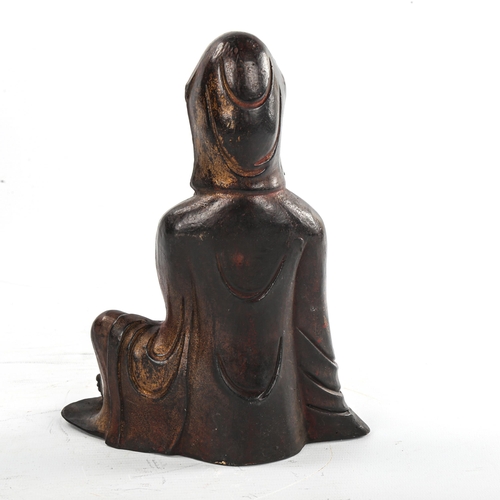 143 - A Chinese patinated seated figure of Guanyin, height 21cm