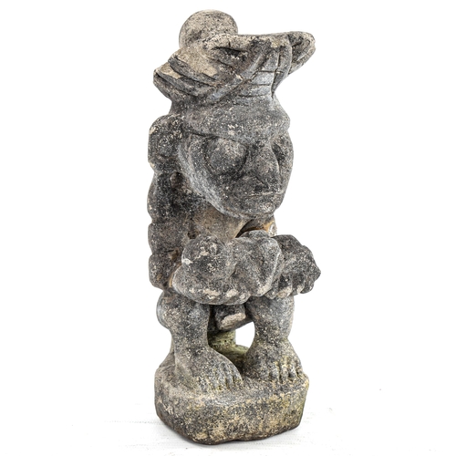 166 - A South American pottery Tribal figure holding a child, height 22cm