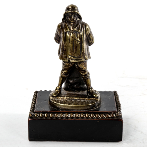 176 - A Victorian cast-brass Vesta stand, in the form of a fisherman, on stained wood base, height 15cm