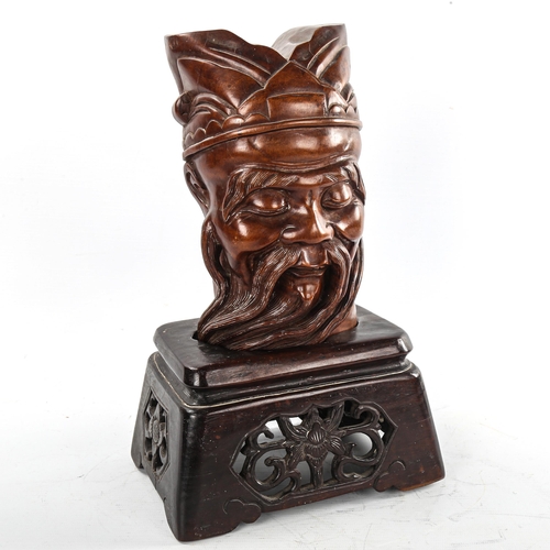 177 - A Chinese carved hardwood head of a man on original carved and pierced wood stand, height 32cm