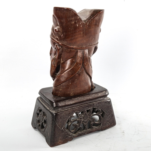 177 - A Chinese carved hardwood head of a man on original carved and pierced wood stand, height 32cm