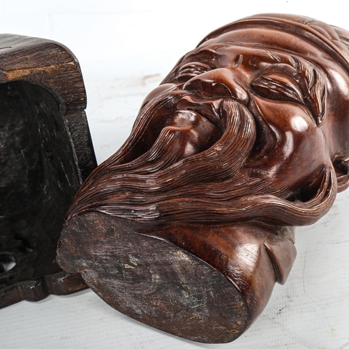 177 - A Chinese carved hardwood head of a man on original carved and pierced wood stand, height 32cm