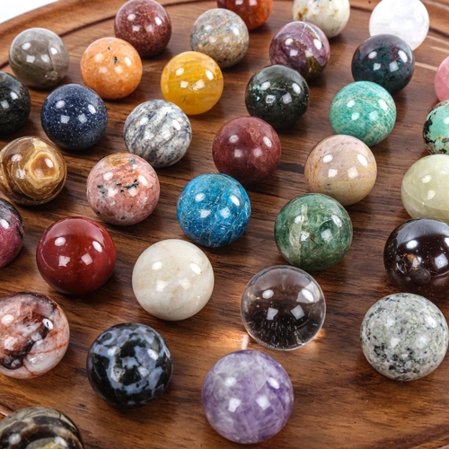 179 - A set of agate and hardstone marbles on turned wood solitaire board, diameter 36cm, marbles diameter... 