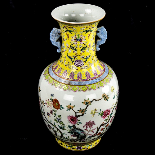 195 - A Chinese white glaze porcelain vase, finely painted enamel flowers with yellow ground neck, seal ma... 