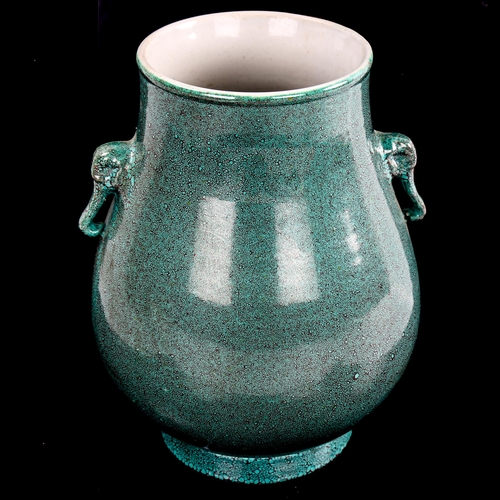 197 - A Chinese mottle green glaze vase with elephant handles, height 19cm