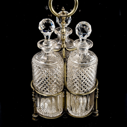 202 - A set of 3 oval cut-glass decanters in original electroplate stand, overall height 35cm