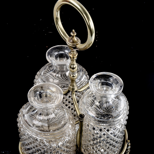 202 - A set of 3 oval cut-glass decanters in original electroplate stand, overall height 35cm