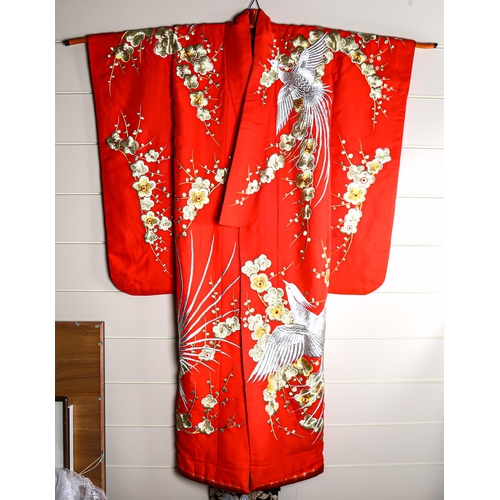 63 - A Japanese wedding kimono, red silk ground with gold and silver embroidered wirework decoration, tog... 