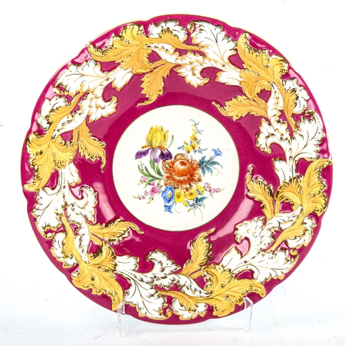 79 - A Meissen porcelain table centre bowl, hand painted botanical centre panel in red and gilt border, d... 