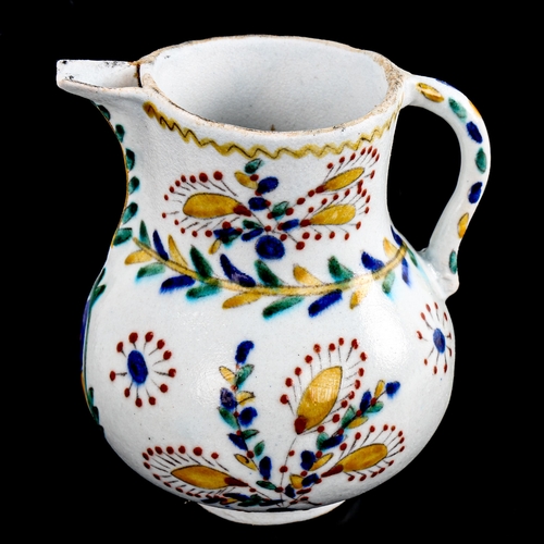 85 - A Turkish Kutahya pottery coffee pot, with painted decoration, height 12cm