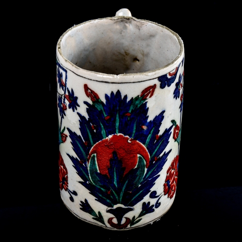 86 - A Turkish pottery pint mug, with painted enamel decoration, height 13cm