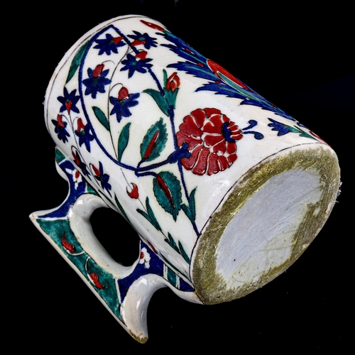 86 - A Turkish pottery pint mug, with painted enamel decoration, height 13cm