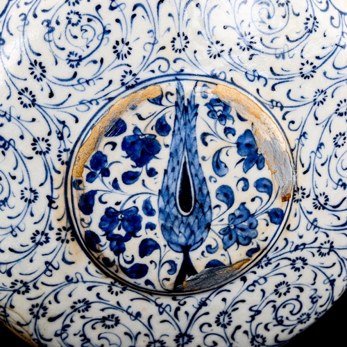 89 - A Turkish pottery moon-shaped water flask, with painted blue and white decoration, height 19cm