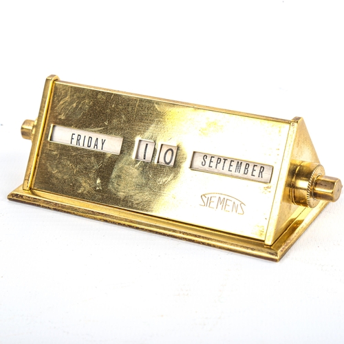 9 - A Siemens polished brass-cased perpetual desk calendar of triangular form, length 11cm