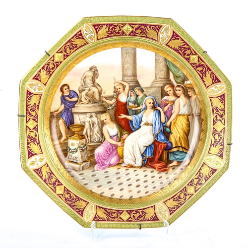 94 - A large Vienna porcelain plate of octagonal form, hand painted Classical temple scene in gilded bord... 