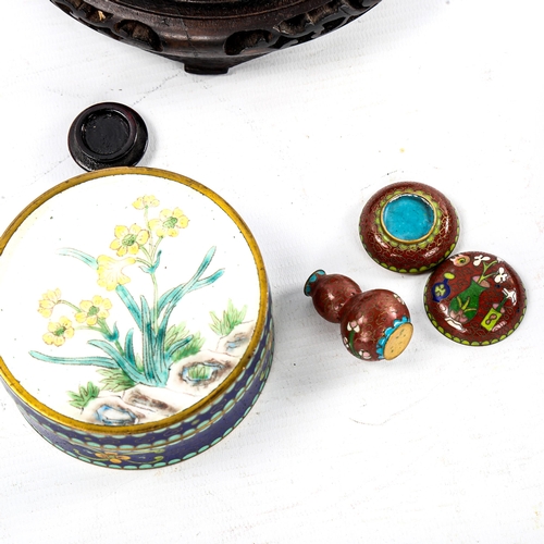 97 - A Japanese blue ground cloisonne enamel bowl, with prunus tree decoration, diameter 20cm, on wood st... 