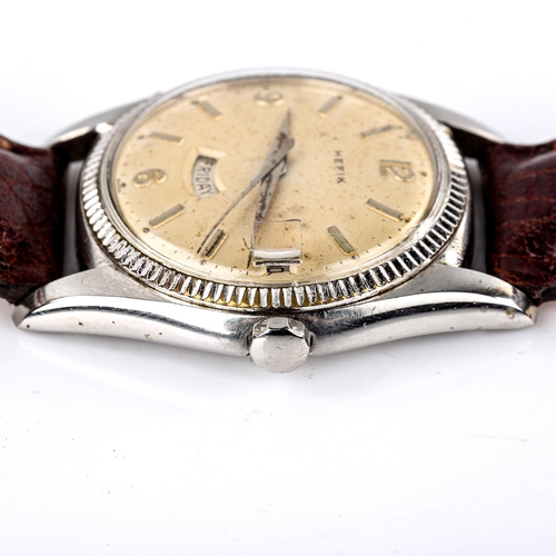 422 - HEFIK - a Vintage stainless steel automatic wristwatch, silvered dial with quarterly Arabic numerals... 