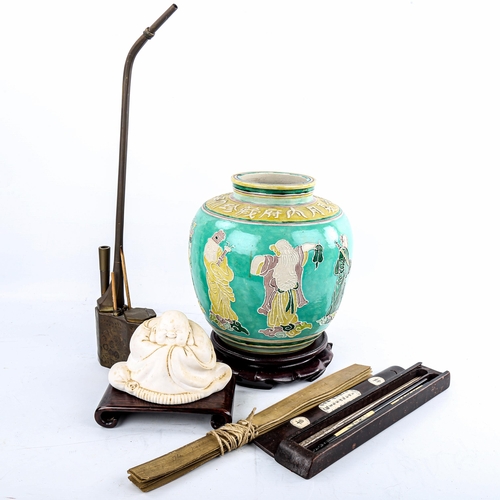 178 - A group of Oriental items, including a relief moulded jar on stand, height 26cm, a brass opium pipe,... 