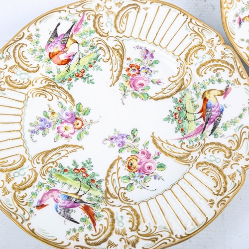 180 - A pair of 19th Continental porcelain plates, with relief-moulded hand painted and gilded exotic bird... 