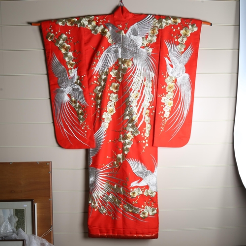 63 - A Japanese wedding kimono, red silk ground with gold and silver embroidered wirework decoration, tog... 