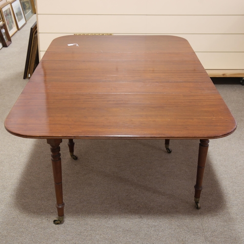 286 - A Georgian mahogany drop leaf extending dining table, with reeded edge, raised on 6 ring turned legs... 