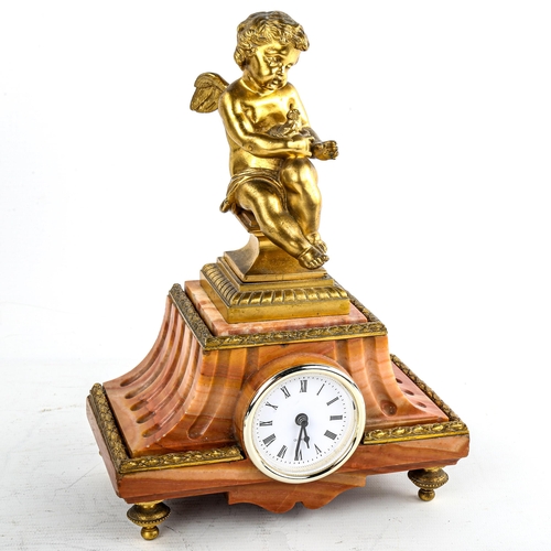 460 - An early 20th century French red marble-cased mantel clock, surmounted by gilt-bronze cherub, overal... 