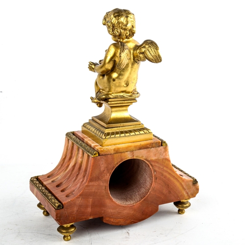 460 - An early 20th century French red marble-cased mantel clock, surmounted by gilt-bronze cherub, overal... 