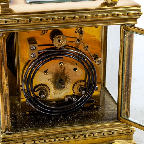 453 - A large French brass-cased carriage clock, by L Vincent of Avignon, oval silvered dial with Roman nu... 