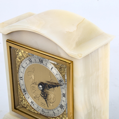 455 - A Vintage polished onyx dome-top mantel clock, by Elliott of London, gilt dial with silvered chapter... 