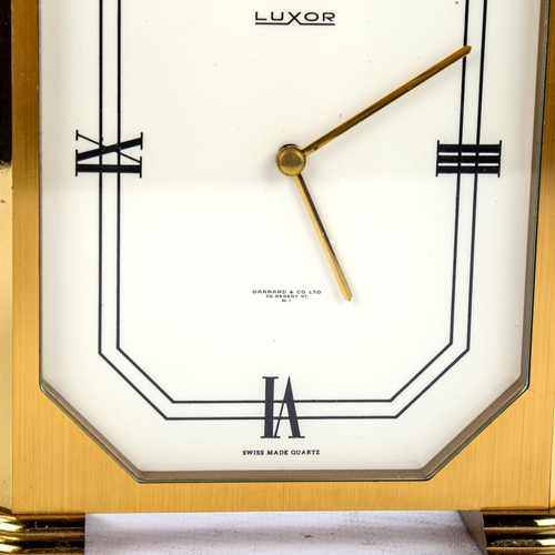 456 - LUXOR - a Vintage brass-cased mantel clock, retailed by Garrard & Co Ltd, white enamel dial with qua... 