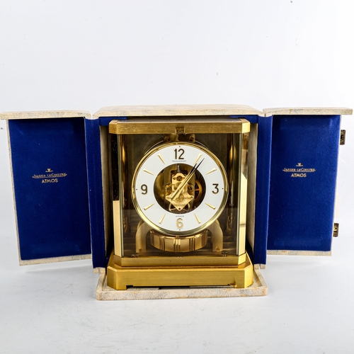 459 - JAEGER LECOULTRE - a Vintage brass-cased Atmos clock, white chapter ring with gilt quarterly Arabic ... 