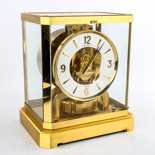 459 - JAEGER LECOULTRE - a Vintage brass-cased Atmos clock, white chapter ring with gilt quarterly Arabic ... 