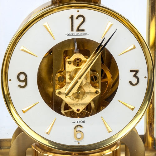 459 - JAEGER LECOULTRE - a Vintage brass-cased Atmos clock, white chapter ring with gilt quarterly Arabic ... 