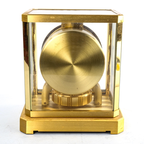 459 - JAEGER LECOULTRE - a Vintage brass-cased Atmos clock, white chapter ring with gilt quarterly Arabic ... 