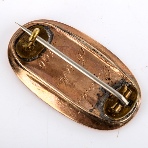 504 - A Georgian oval mourning brooch, unmarked gold settings, with lattice woven hair panel and applied g... 