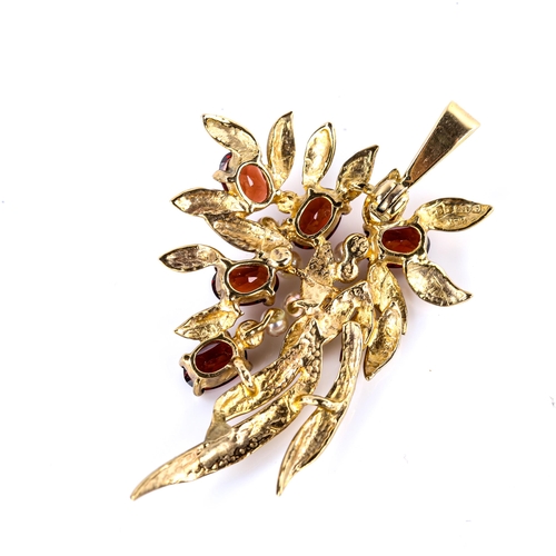 511 - A late 20th century 9ct gold garnet and pearl floral spray pendant, set with oval mixed-cut garnets,... 