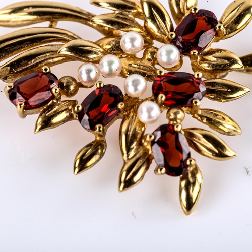 511 - A late 20th century 9ct gold garnet and pearl floral spray pendant, set with oval mixed-cut garnets,... 